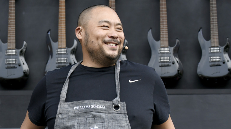 David Chang smiling near guitars