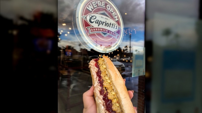 Outside a Capriotti's shop with a Bobbie sandwich