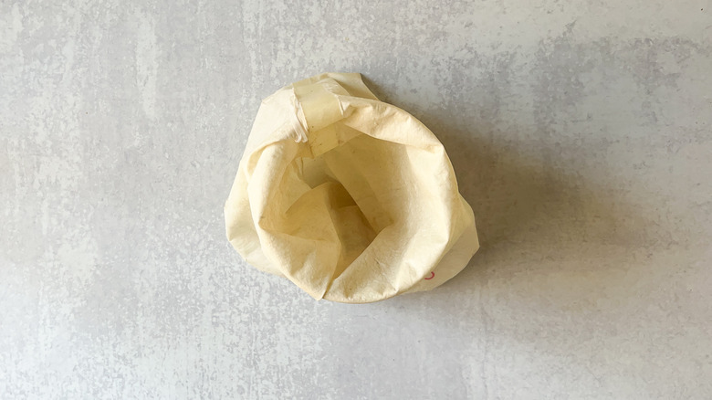 Pastry bag folded over container for filling