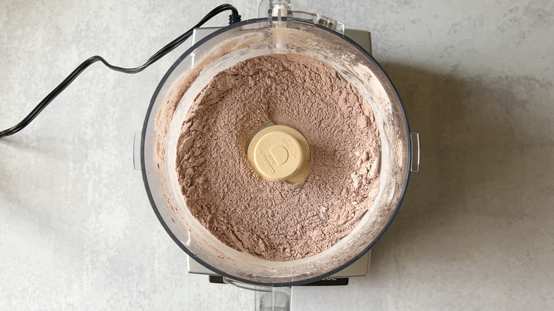 Chocolate macaron ingredients in food processor bowl