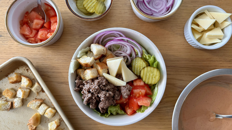 Assembling cheeseburger bowls