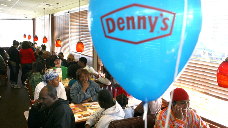 Blue Denny's balloon and diners in restaurant