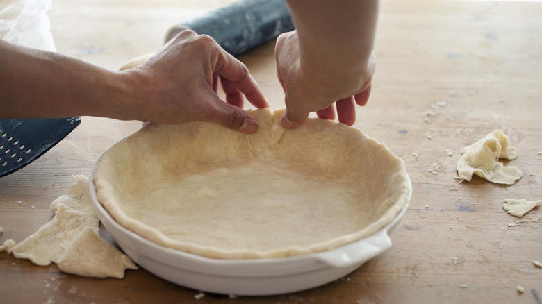 Hands forming a pie crust