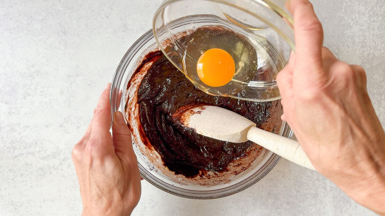 Mixing eggs into brownie batter