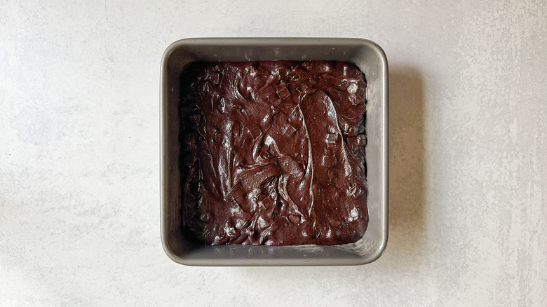 Brownie batter in square baking pan