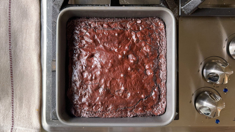 Brownies cooling in square pan on stovetop