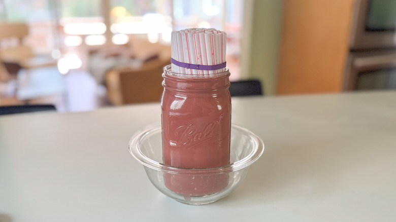 straws in jar with red liquid