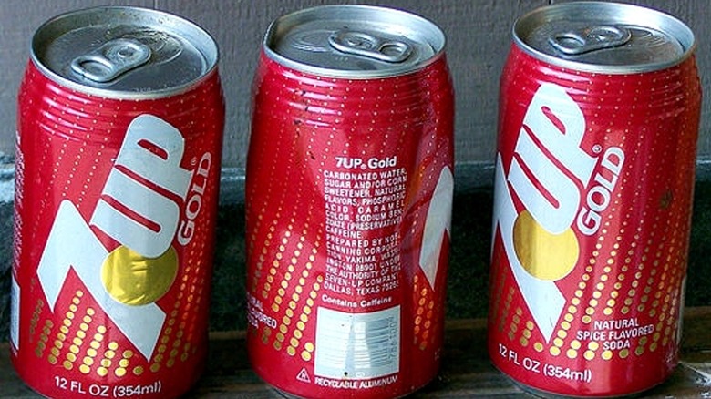 Three unopened cans of 7Up Gold