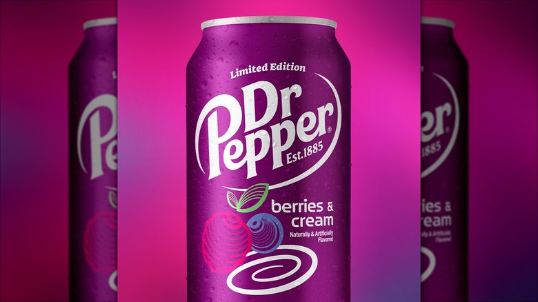 A can of Dr. Pepper Berries & Cream on a purple and pink background