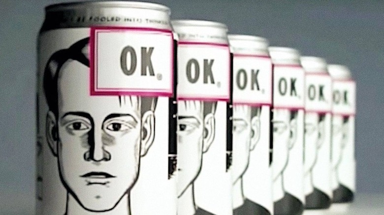 A line of identical OK Soda cans