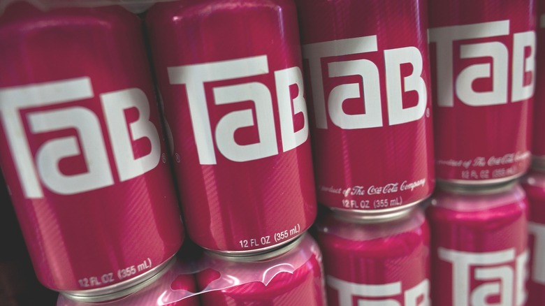 Close-up of TaB soda cans stacked on each other