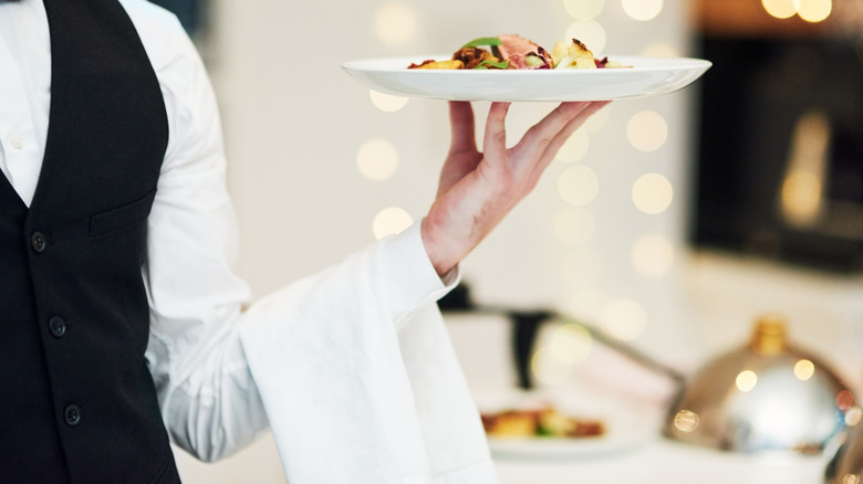 fine dining waiter holding a plate