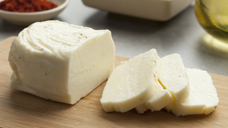 Piece of fresh sliced halloumi on a cutting board