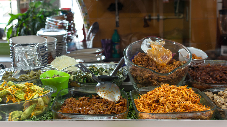 Glass dishes of seasoned meats for a taco bar