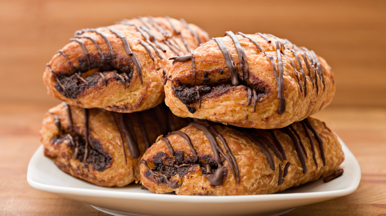 Four chocolate croissants on plate
