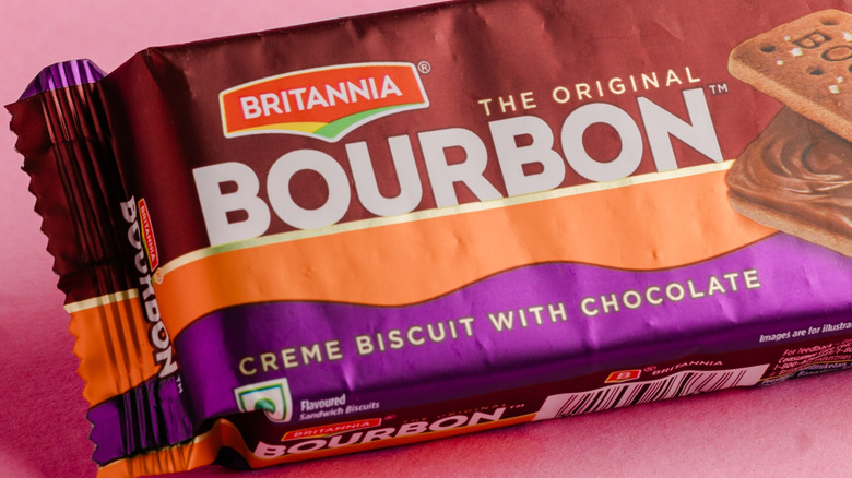A pack of Britannie Bourbon biscuits on a pink background