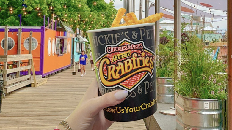 Person holding bucket of Crabfries