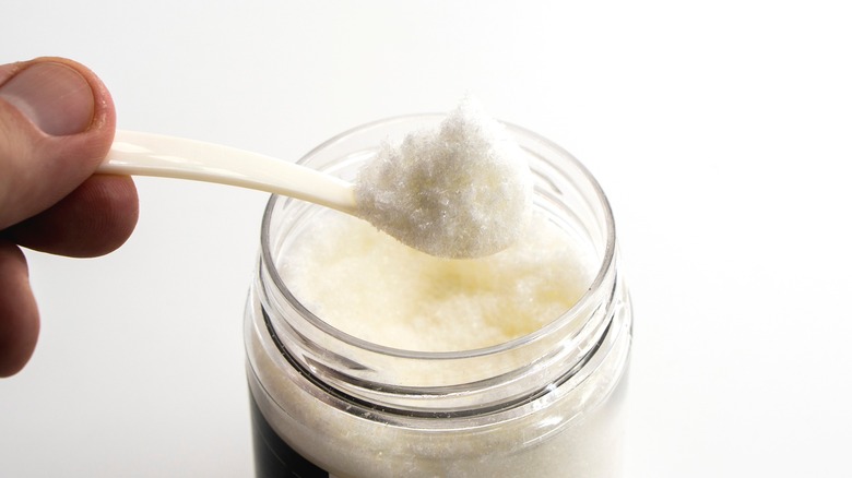 Small spoonful of monosodium glutamate scooped from a jar