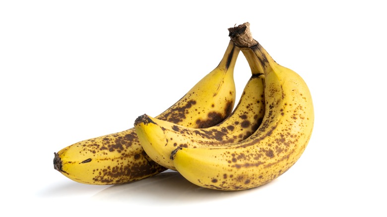 overripe bananas on white background 