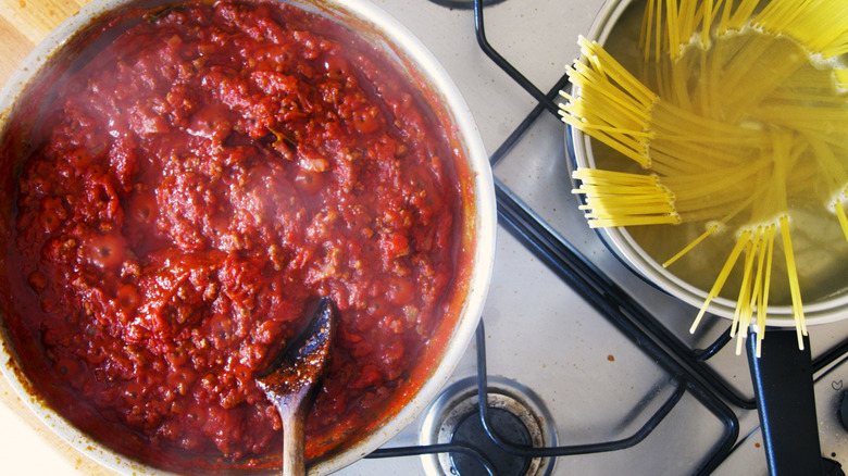 Tomato sauce and noodles cooking on the stove