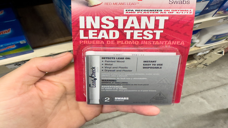 Lead testing kit held up against store shelf