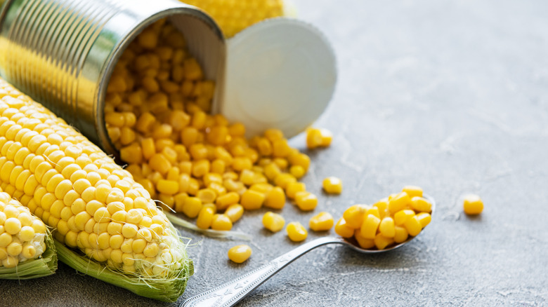 Open can of corn spilling onto the countertop