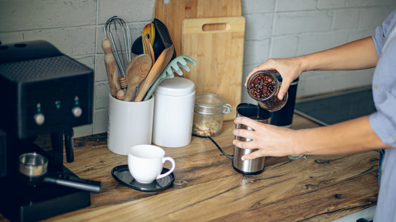 woman making coffee in kitchen