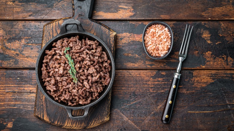 Ground beef on wood background