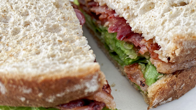 A center view of a BLT made with untoasted bread in close up