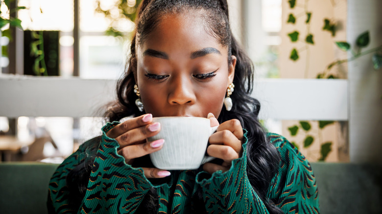 A woman drinking coffee