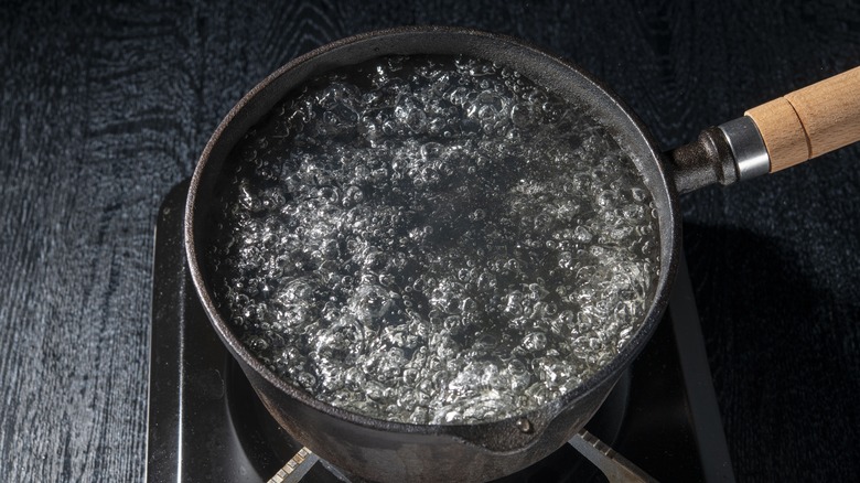 Black pot of boiling water