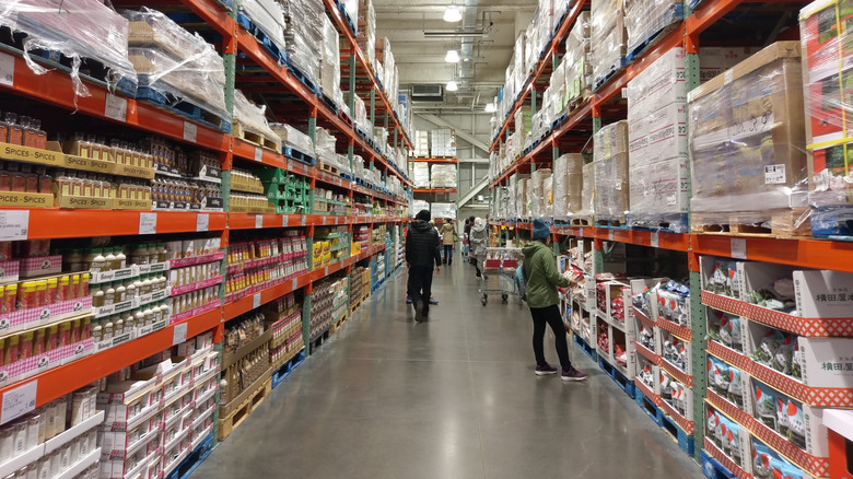 People shopping in food aisle of Costco