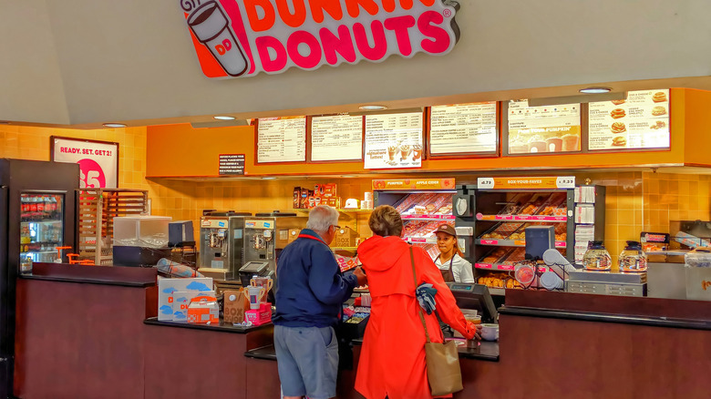 Two people ordering at Dunkin' Donuts