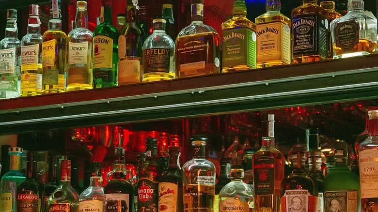 Liquor bottles on a wall behind a bar