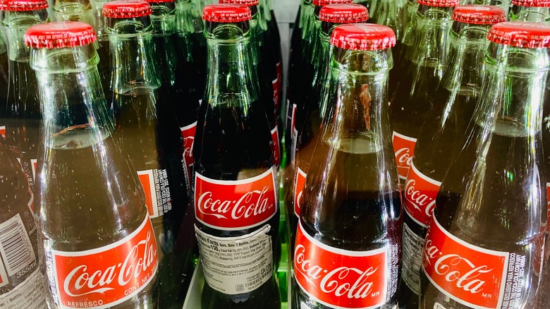 Refrigerator filled with bottles of Mexican Coke