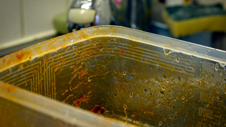 Plastic container stained with tomato sauce