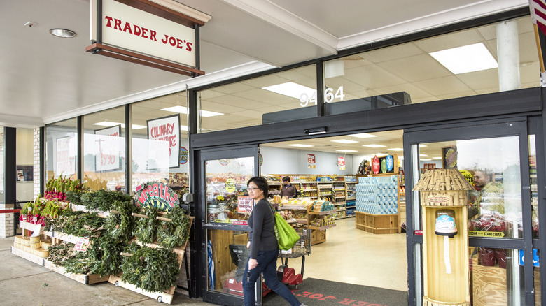 Woman walking out of a Trader Joe's store