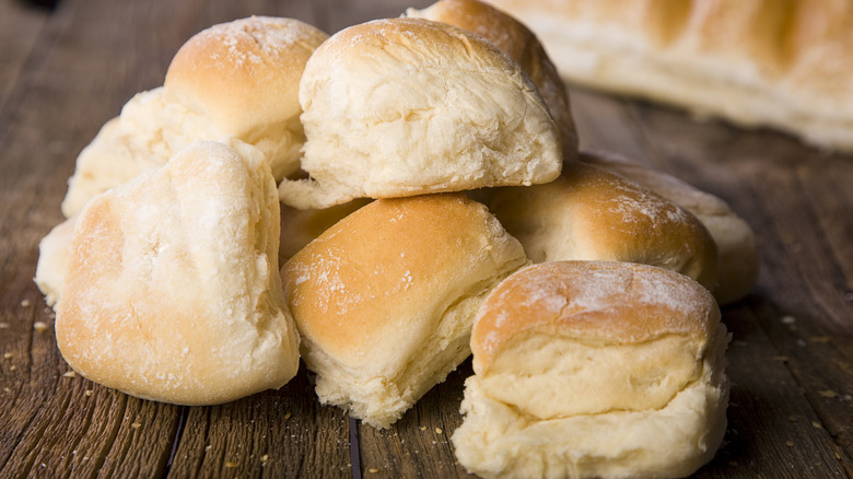 A pile of dinner rolls on a table