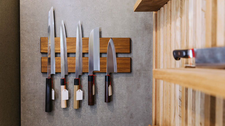 Knives mounted on the wall with a magnetic knife strip