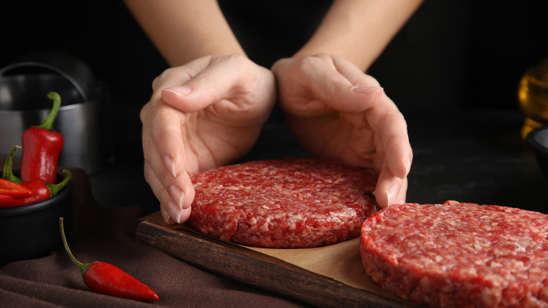 Hands gently forming ground beef patties