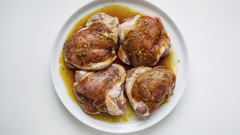 top down view of chicken marinating on plate