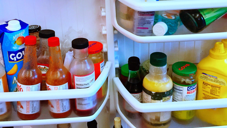 Jumbled condiments in a fridge