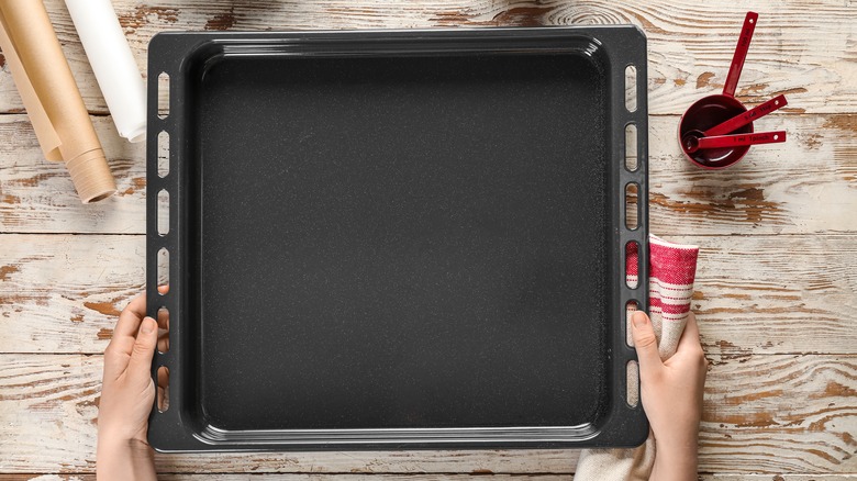 someone preparing a baking pan