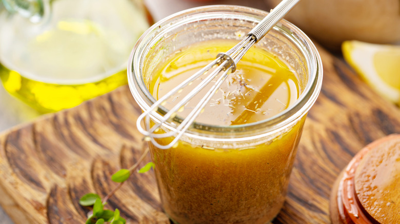 Mustard-infused marinade in glass jar