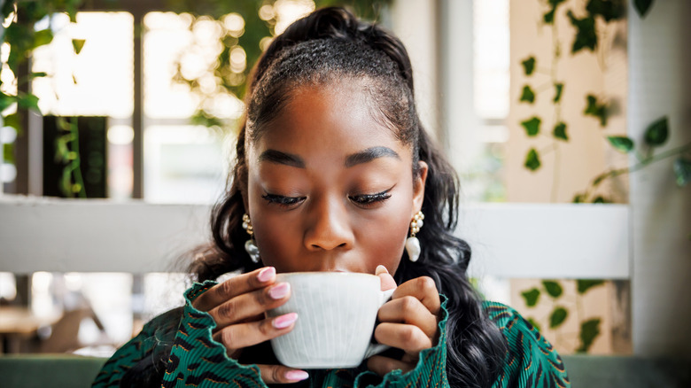 a woman enjoying a cup of coffee
