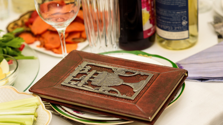 Passover seder table set with Haggadah