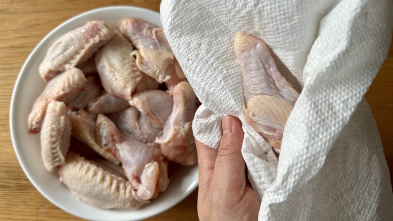 raw chicken wings with paper towel