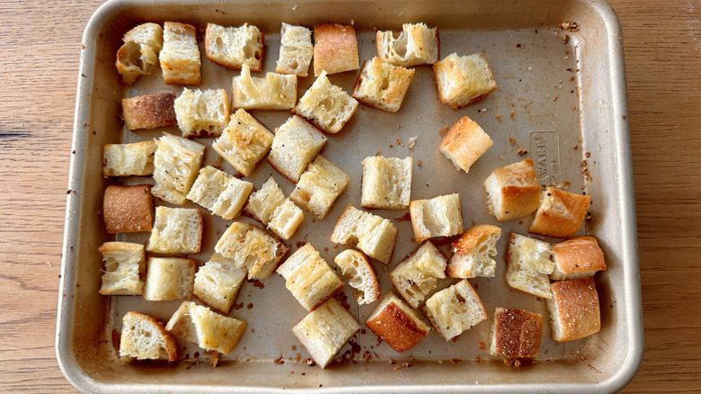 Baked croutons on baking sheet