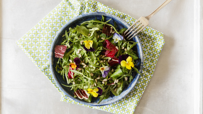 Arugula salad with edible flowers