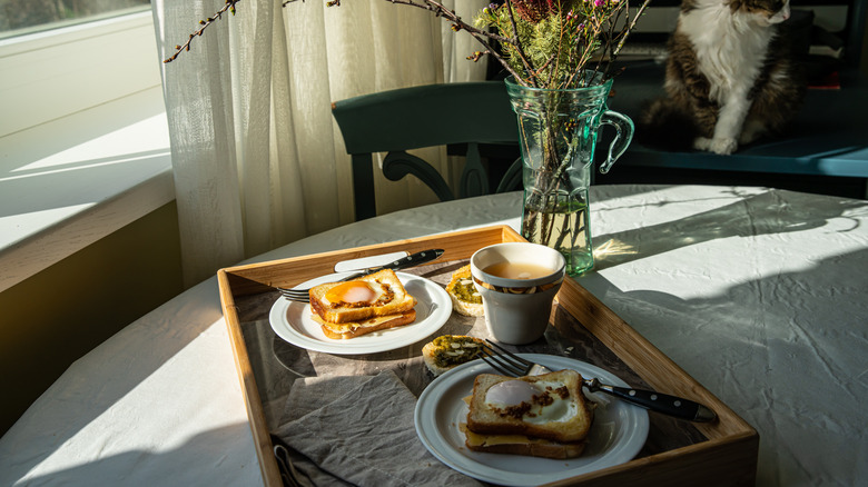 Egg-in-a-hole grilled cheese sandwiches for two on table